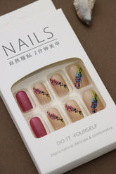 Nude Press-On Nails with Vibrant Floral Pattern and Maroon Accent – Nature’s Touch
