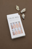 Elevate your style with these elegant press-on nails! Featuring soft peach tones with artistic white and gold waves, they add a touch of sophistication to any look. Perfect for every occasion!