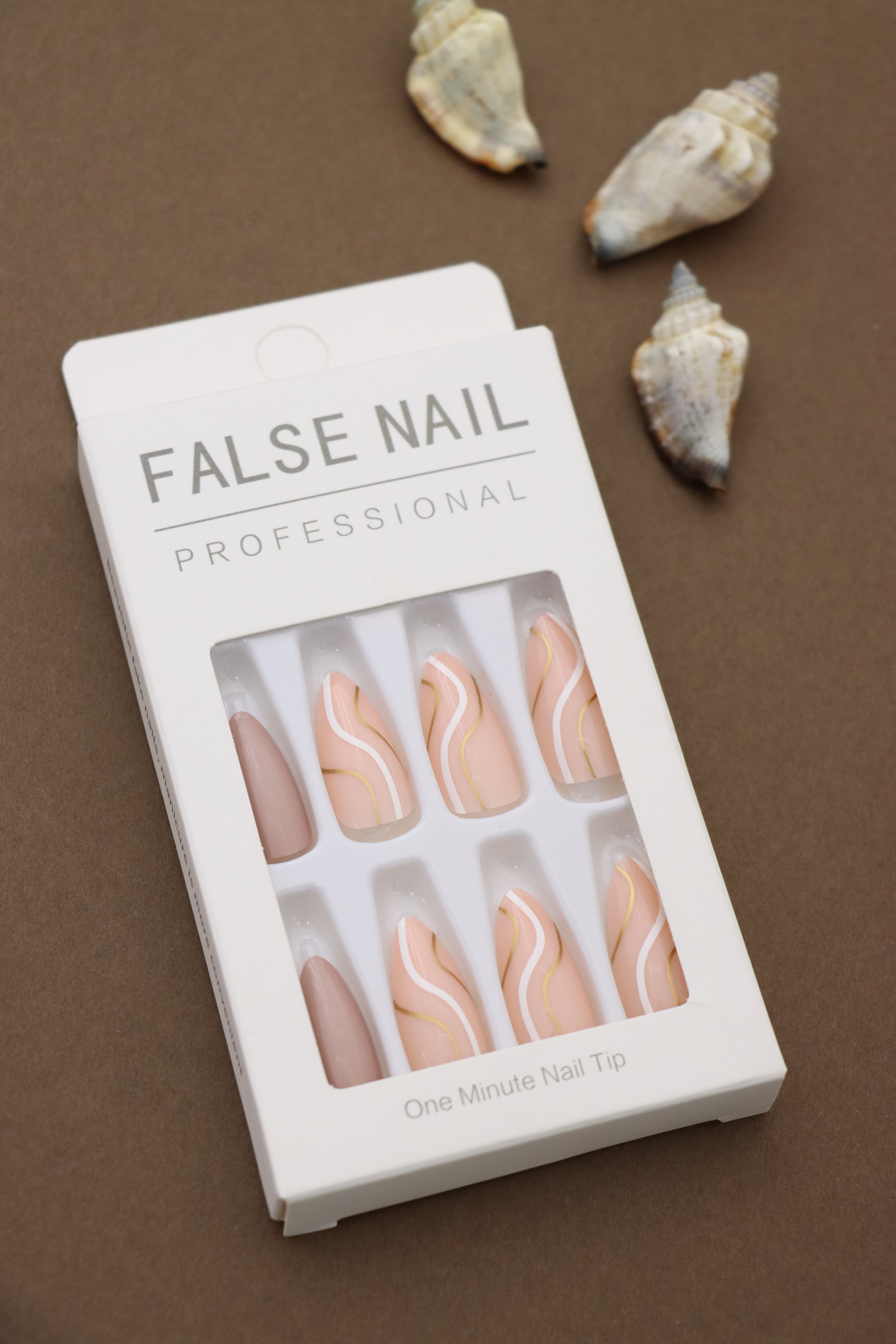Elevate your style with these elegant press-on nails! Featuring soft peach tones with artistic white and gold waves, they add a touch of sophistication to any look. Perfect for every occasion!