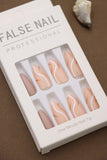 Elevate your style with these elegant press-on nails! Featuring soft peach tones with artistic white and gold waves, they add a touch of sophistication to any look. Perfect for every occasion!
