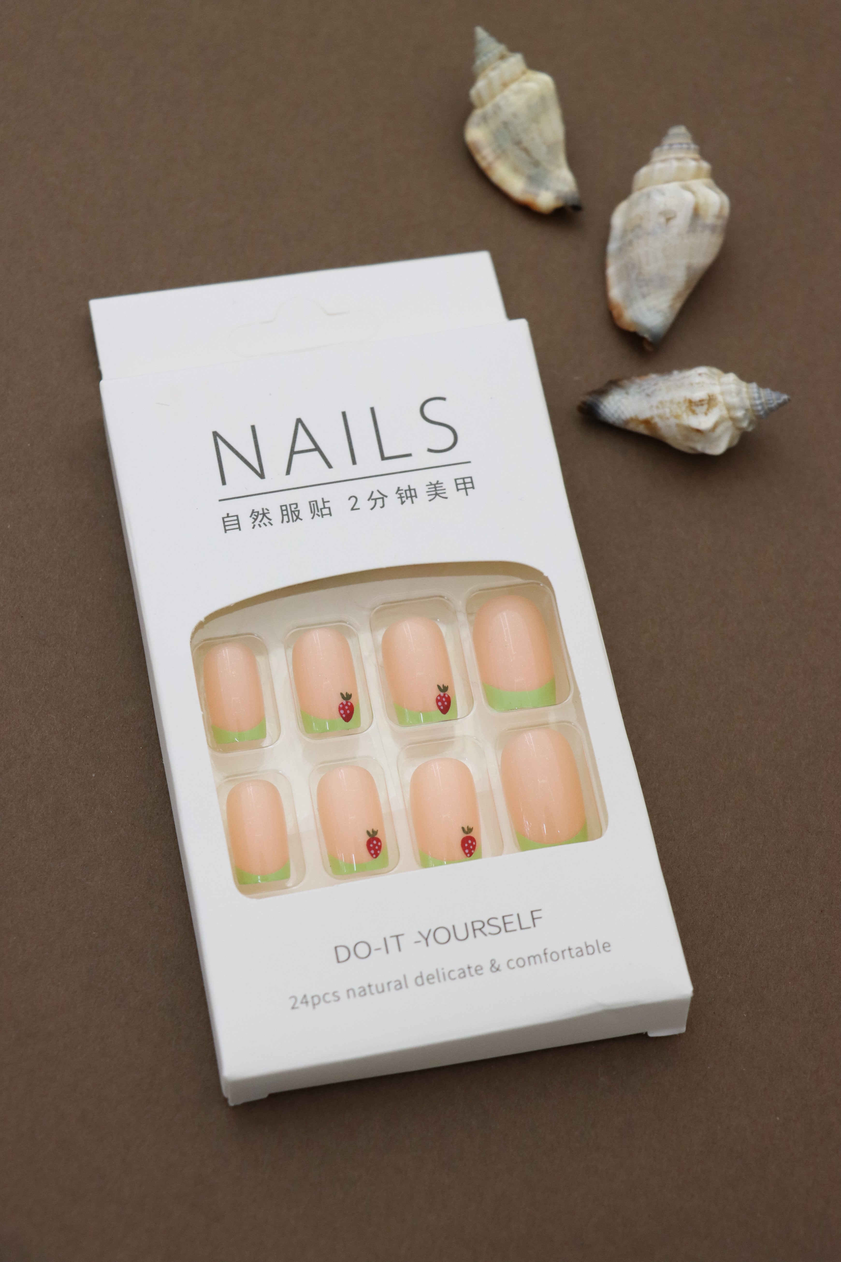Playful Delight: Soft Peach Nails with Green Tips and Adorable Strawberry Accents – A Refreshing Pick for a Fun Look!