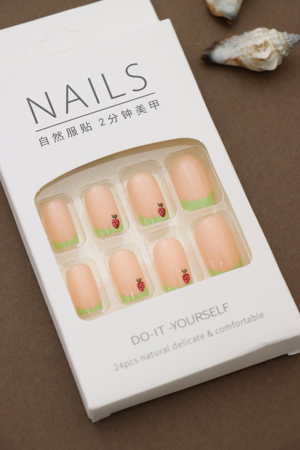 Playful Delight: Soft Peach Nails with Green Tips and Adorable Strawberry Accents – A Refreshing Pick for a Fun Look!