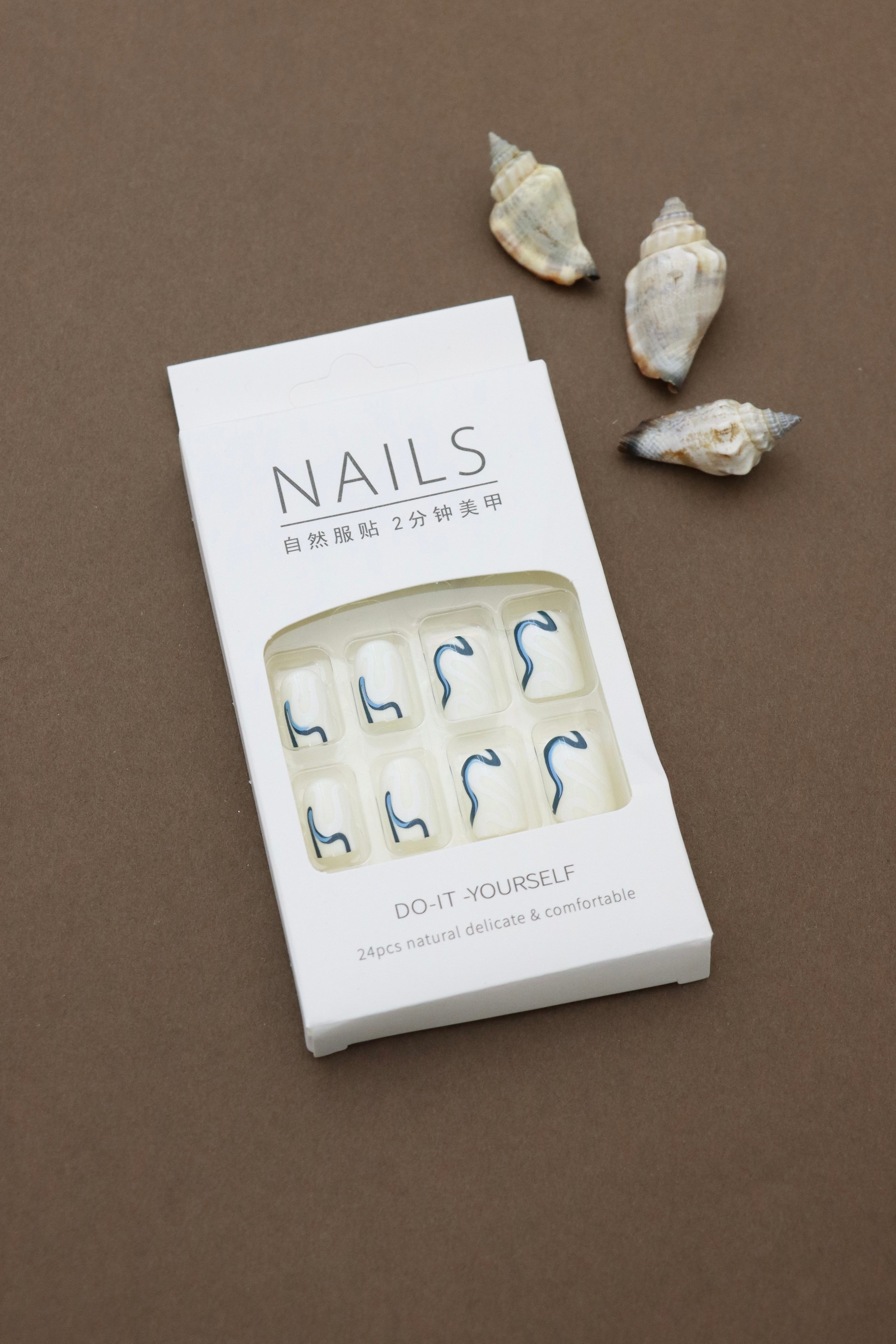 Elegant Waves: Minimalist White Nails Enhanced with Bold Blue Swirls – Perfect for a Chic and Modern Look!