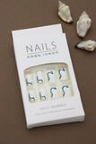 Elegant Waves: Minimalist White Nails Enhanced with Bold Blue Swirls – Perfect for a Chic and Modern Look!