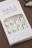 Elegant Waves: Minimalist White Nails Enhanced with Bold Blue Swirls – Perfect for a Chic and Modern Look!
