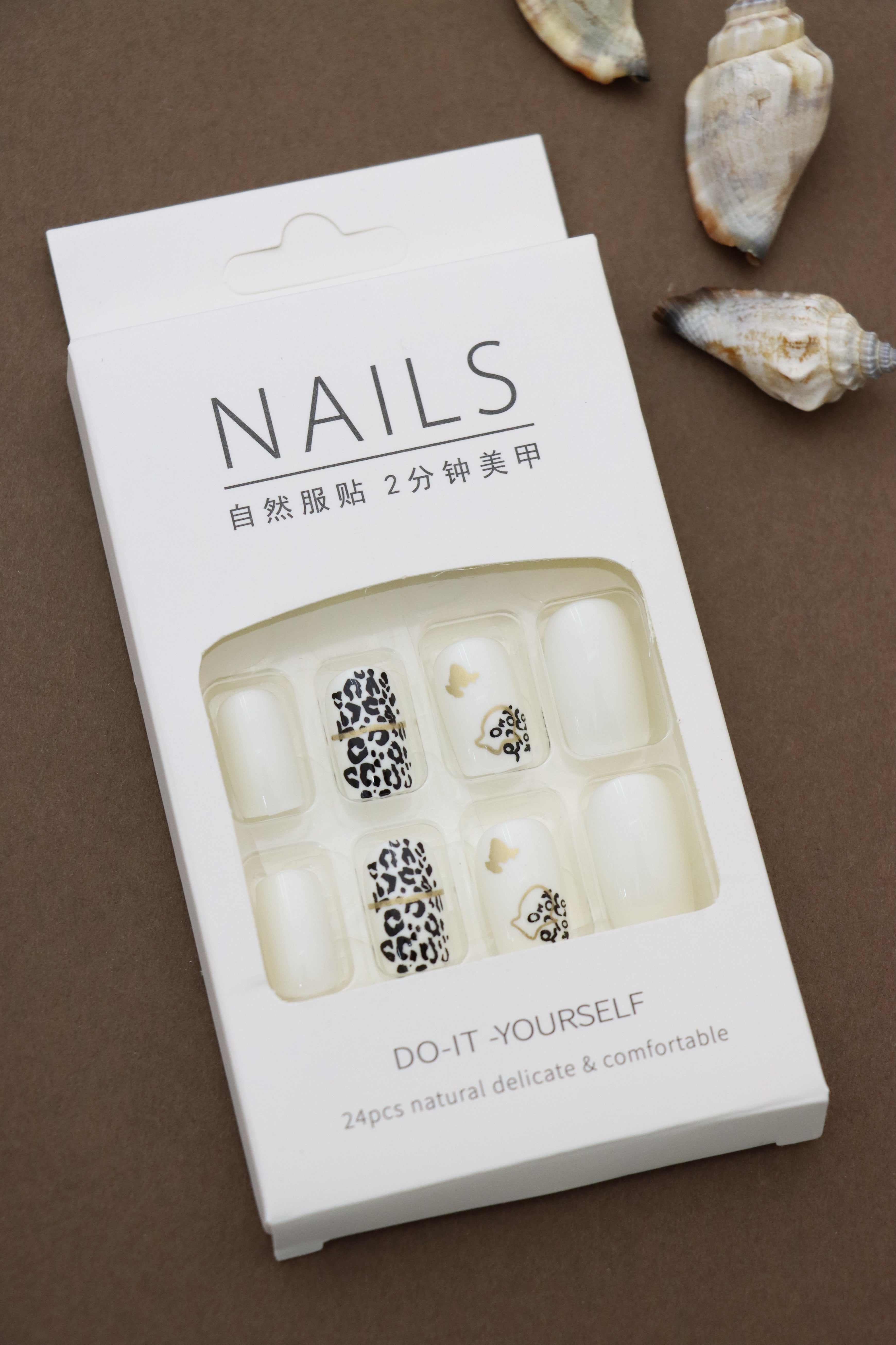 Unleash your wild side with these chic leopard-print nails, accented by delicate gold details and butterflies for a touch of elegance. Perfect for making a statement!