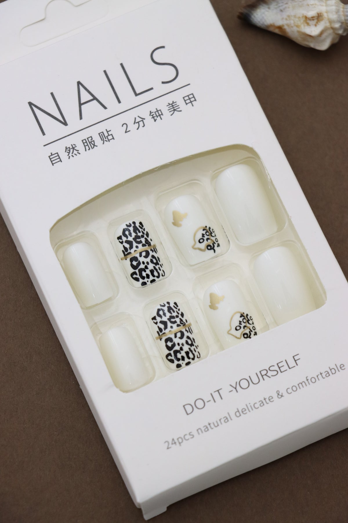Unleash your wild side with these chic leopard-print nails, accented by delicate gold details and butterflies for a touch of elegance. Perfect for making a statement!