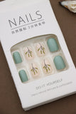 Earthy Greenery – A Tranquil Blend of Mint Green Solids and Elegant Leafy Accents. These Nature-Inspired Press-On Nails Offer Effortless Style and Natural Beauty for Your Everyday Look.